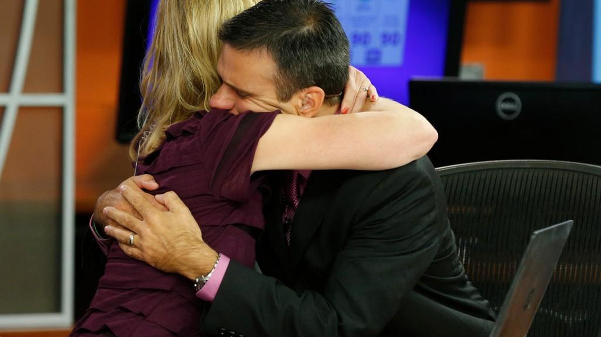 
WDBJ-TV7 news morning anchor Kimberly McBroom hugs meteorologist Leo Hirsbrunner after their early morning newscast at the station on Thursday
