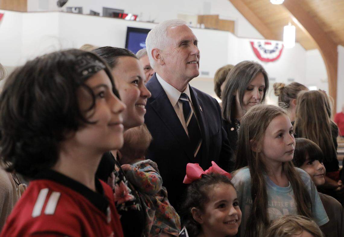 Former Vice President Mike Pence poses for a photo with a family Thursday at Lakewood Baptist Church where he was a guest speaker.