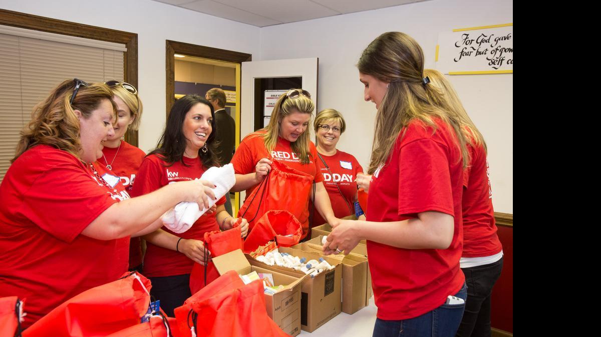 
Member of the Keller Williams team pack toiletry bags as Keller Williams Realty of Fort Mill hold a Red Day charity event at the ROC Thursday.

