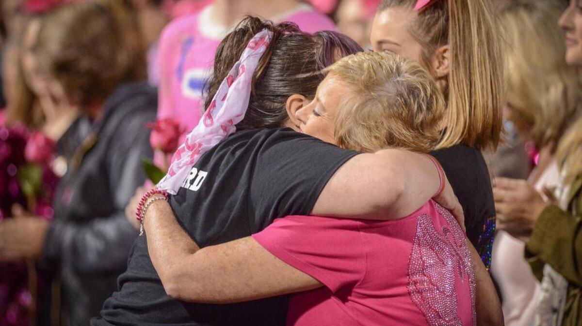 Libby Meadows, right, of Fort Mill gets a hug from Andrea Godbolt, the founder of the Pink Out.