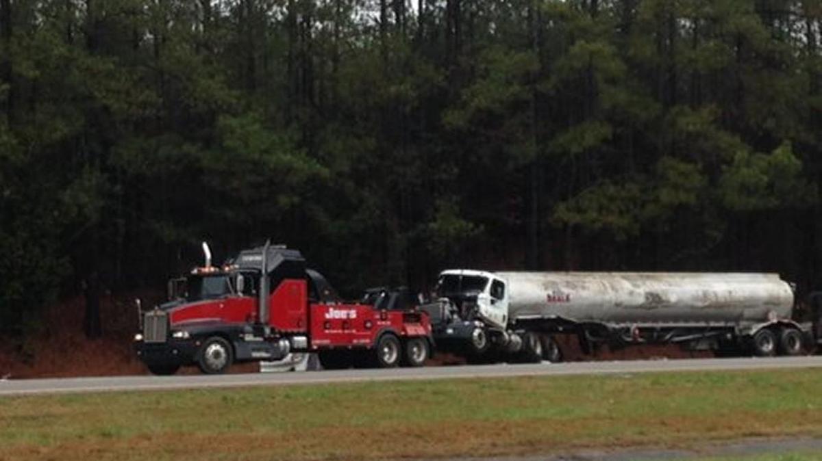 Crews turn a tanker upright after it overturned Tuesday morning on I-77 in Chester County.