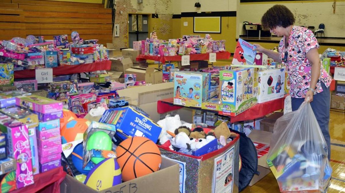 Volunteer coordinator Trina Ricks sorts through toys earlier this month at the Holiday Partners toy drive.