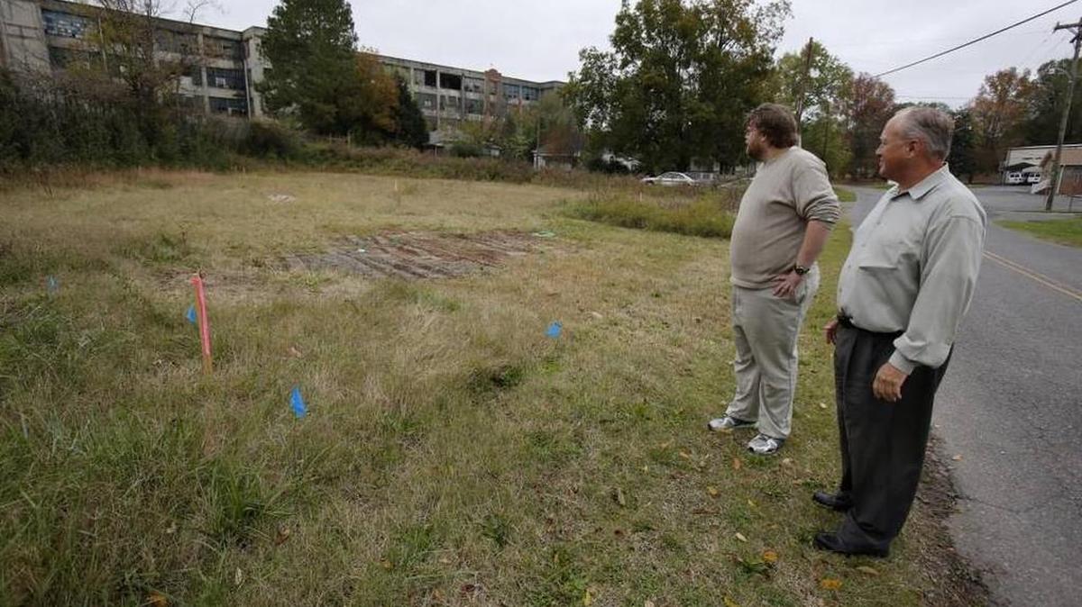 Neighbor Ed Dees Jr. left, and Clover Town Councilman Todd Blanton look over the site for the proposed cell tower on Walnut Street in this Herald file photo.