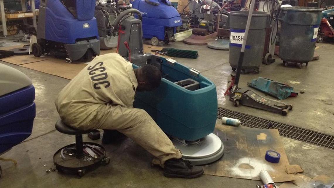 
An inmate refurbishes a buffing machine while working for Southeastern Equipment, a service program.

