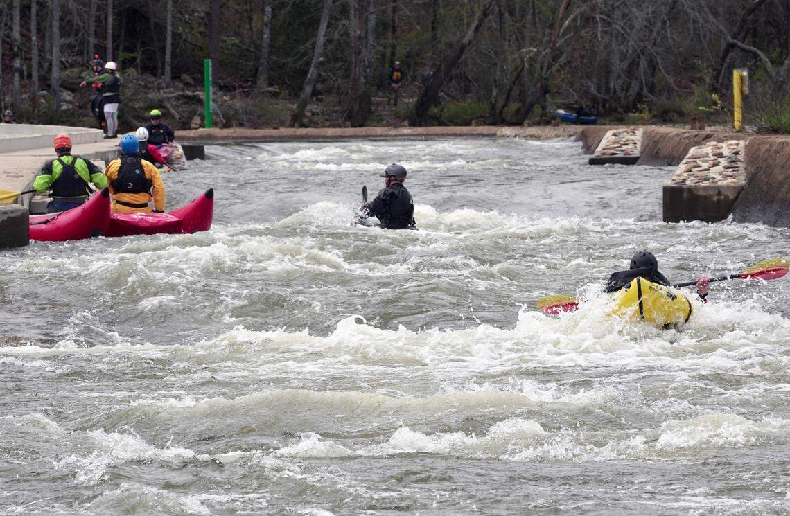 Kayakers paddle on the “paperclip” bypass on the Catawba River in Great Falls on March 19.