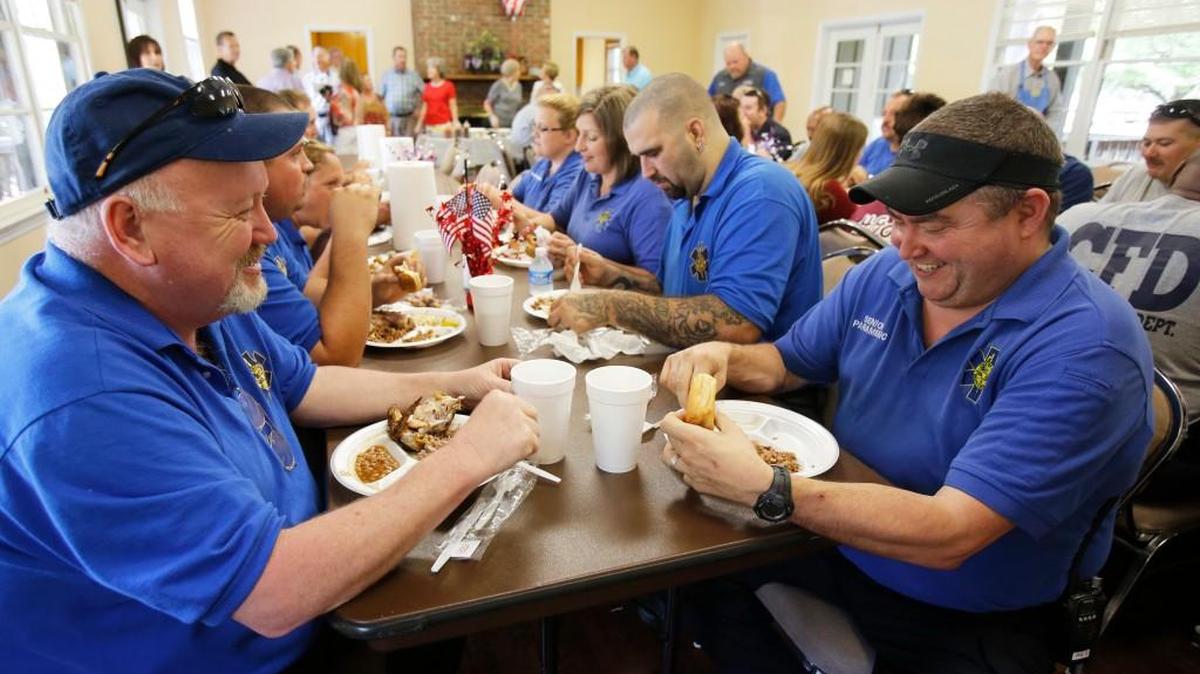 
Frankie Wofford, left, and Phil Gregory, right, both with Chester County EMS enjoy BBQ at the lunch.
