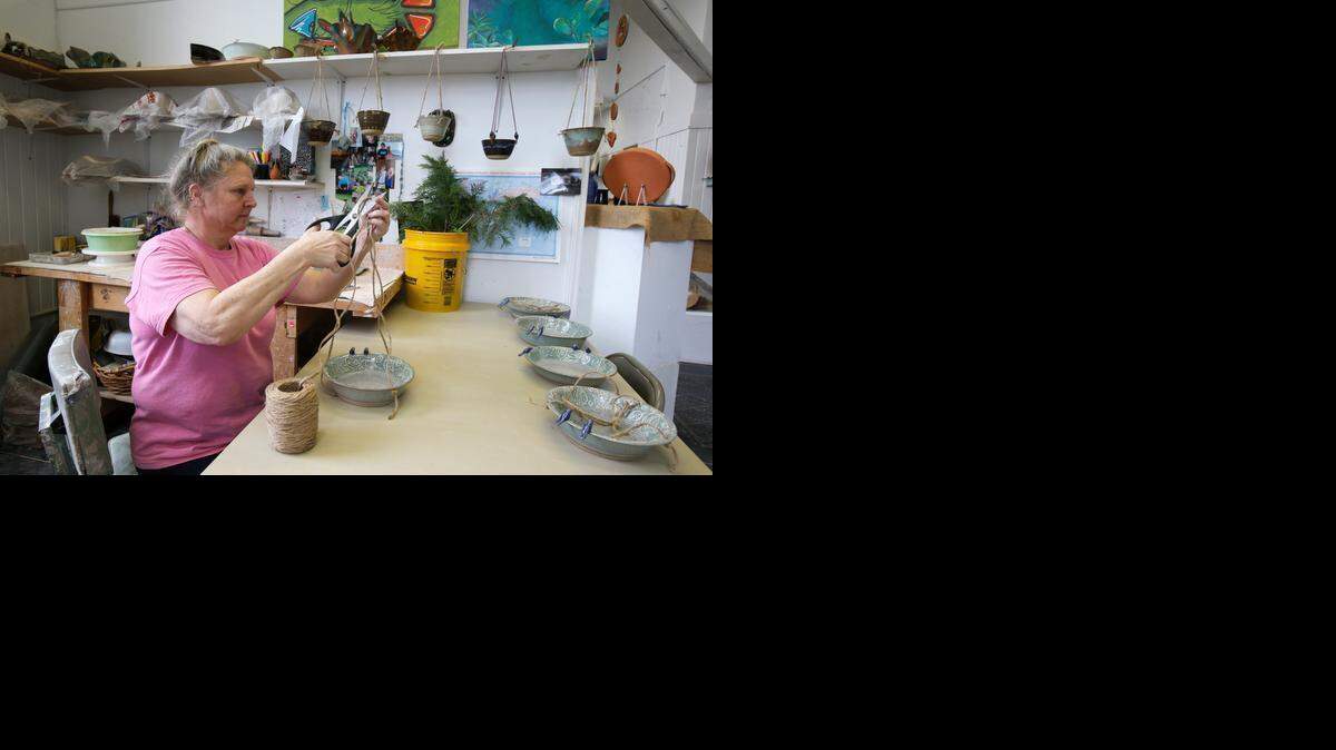
Potter Katherine Petke works on a pottery bird feeder in the studio she shares with Liz Lee at the Gettys Art Center Wednesday. Their space also includes a gallery where they sell their work.
