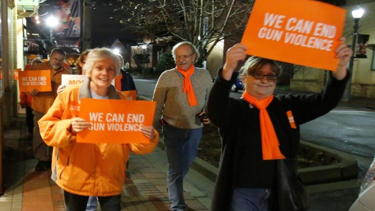 A group of residents walked from the Episcopal Church of Our Saviour in downtown Rock Hill to The Herald Monday night to deliver letters to the editor in support of better gun laws. Diane Rudulph, right, leads the group on their march through downtown Rock Hill.