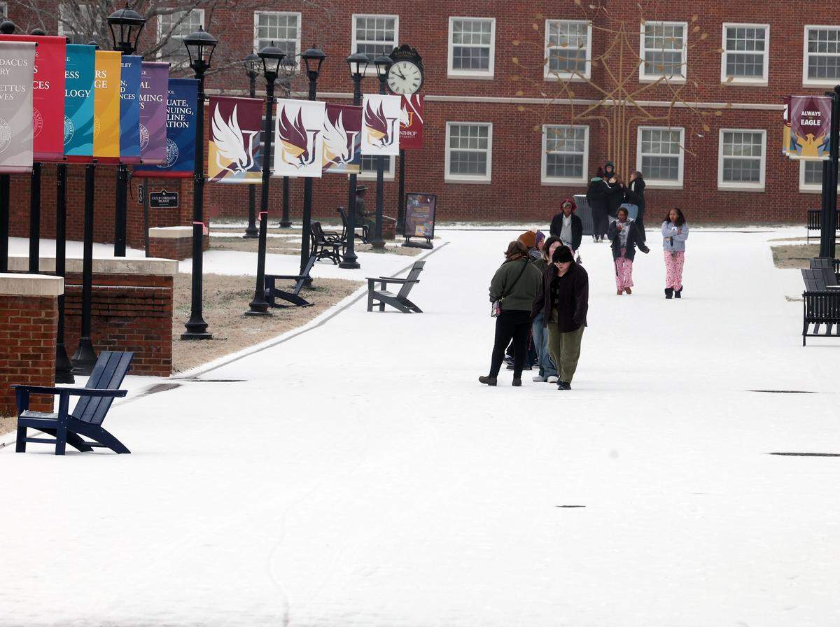 Winthrop University students walk on campus to survey the wintry mix that fell early Sunday, Jan. 25, 2025 in Rock Hill.