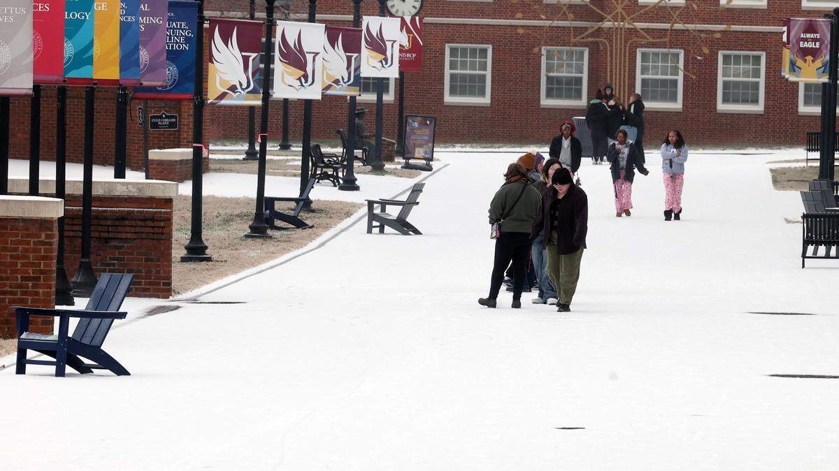 Winthrop University students walk on campus to survey the wintry mix that fell early Sunday, Jan. 25, 2025 in Rock Hill. Public school districts are canceling events this weekend due to forecasts of heavy snow.