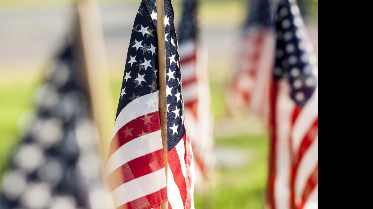 
American flags mark the graves of veterans at Laurelwood Cemetery in Rock Hill on Sunday.
