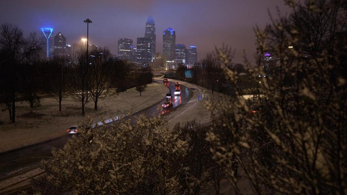 Commuters brave ice and snow as they head toward uptown Charlotte early Friday morning, January 22, 2016.