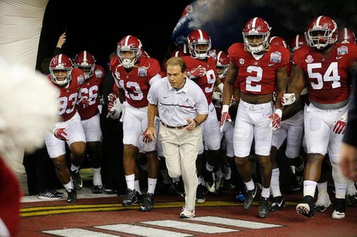 Alabama head coach Nick Saban and players enter the field for the first half of the Dec. 31, 2016 Peach Bowl college football playoff game against Washington in Atlanta.