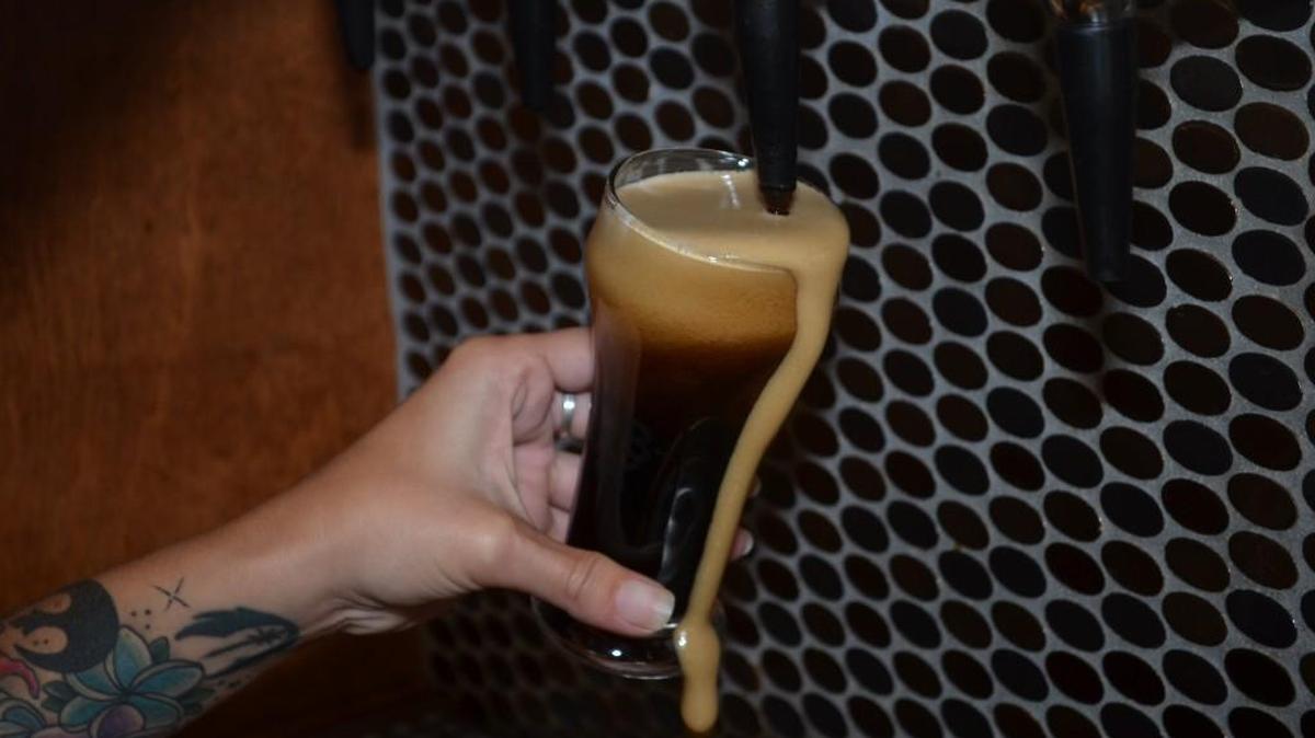 Beer foam slides down a glass after a pour at the Legal Remedy Brewing Company in Rock Hill.
