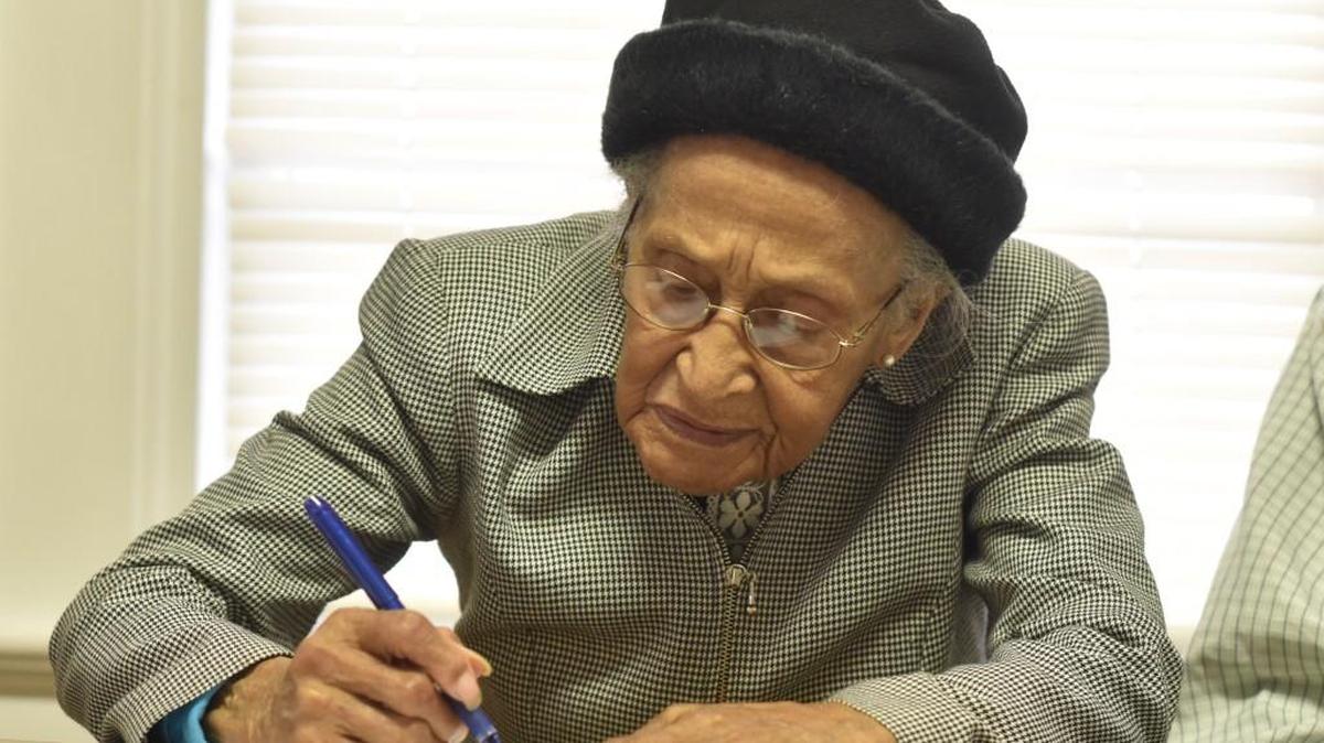Eloise Miller of Rock Hill signs documents Monday placing 53 acres of her family farm into a conservation easement held by the Nation Ford Land Trust.