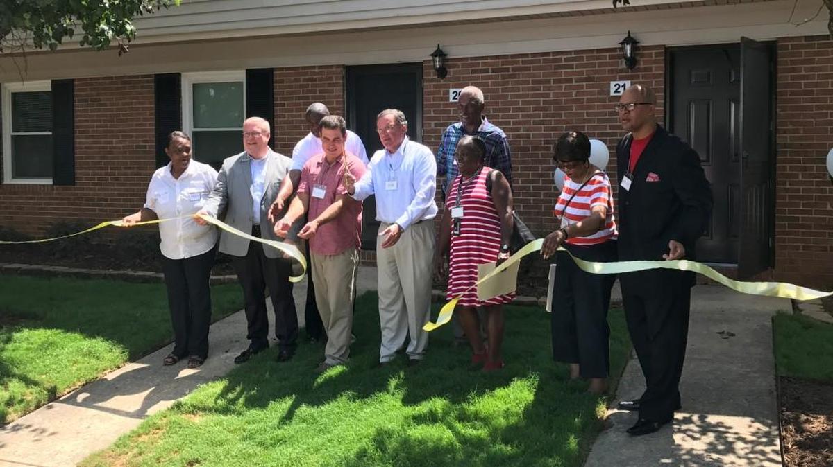 Cutting the ribbon to open the Chester County apartment complex that recentely underwent a $1.3 million rehabilitation in front from left are Barbara Gaston, Jim Bennett, Great Falls Mayor Lee Montgomery, commissioners David Casey and Tammy Gordon, the Rev. Curtis Cohens. In back are Dewayne Alford, Dewayne Alford, executive director of the Carolina Housing and Community Development Corporation and Darrel Williams.