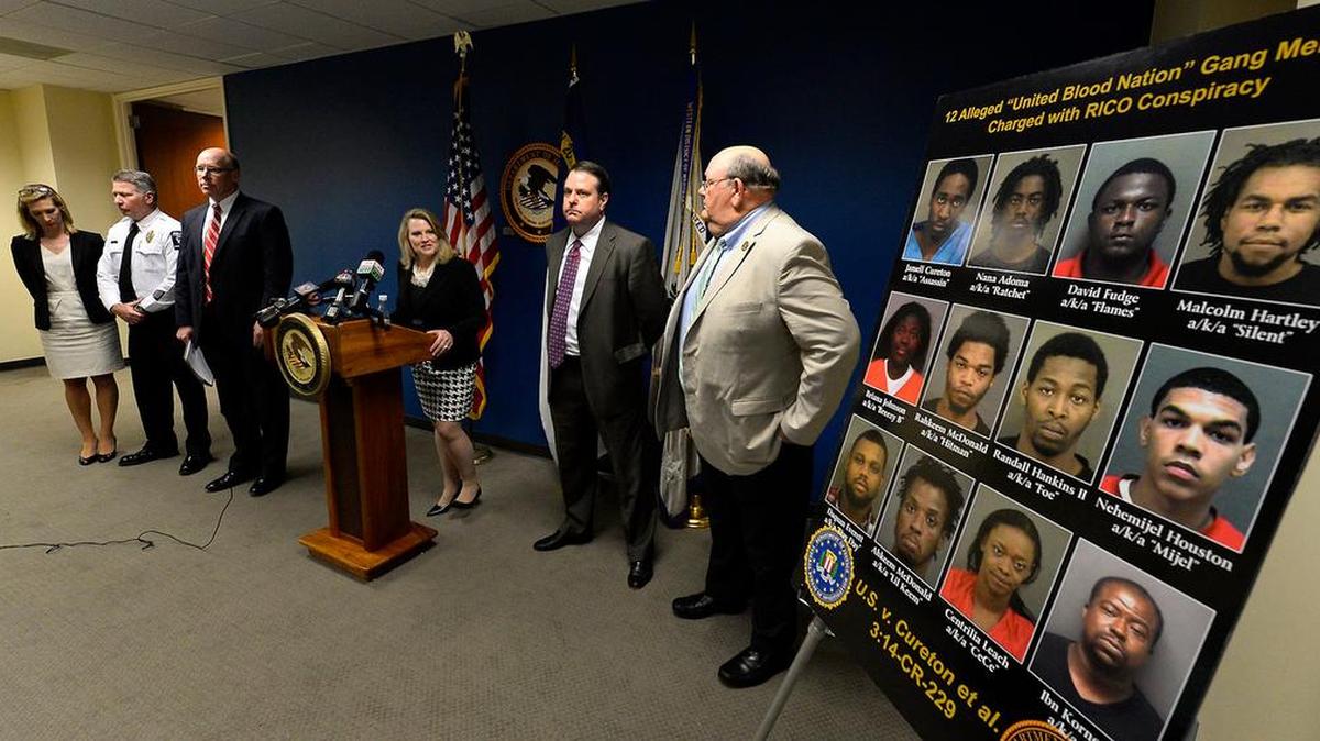 U.S. Attorney Jill Rose and other federal, state and local officials announce the arrests of a dozen United Blood Nation members from Charlotte connected to the killing of Doug and Debbie London in 2014.