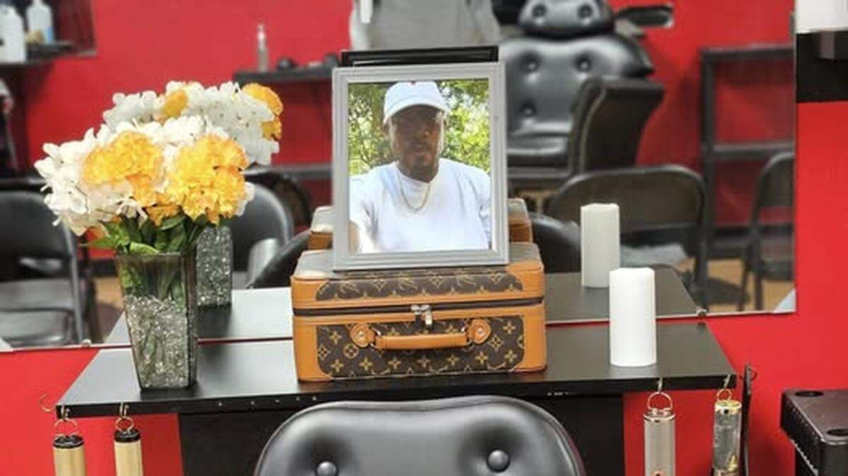A photo of Israel Bunting V of Chester, South Carolina is on display near his barber chair where he worked at Razors barbershop. SLED is investigating his death after his body was found in a car fire Nov. 30, 2024.