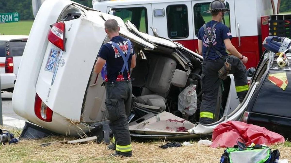 Rock Hill firefighters cut the top off of an overturned Camry to rescue three people trapped inside after a collision in June. A female victim later died. By Bristow Marchant