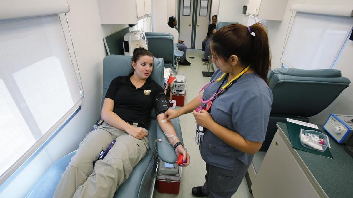 
The York County Sheriff's Office is holding a blood drive, "Badges for Blood," on three different days this week. Jenny Cedeno, Donor Services Technician with Community Blood Center of the Carolinas, right, prepares Amber Boyle, with Probation and Parole, for giving blood Monday morning at the Moss Justice Center.
