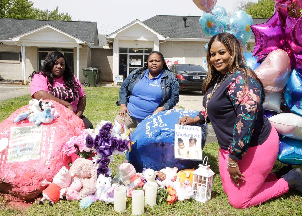From left, teacher Tara Parker, floor director Kianna Sanders and owner of Right Choice Child Development Center, Sidnetrice Williams, kneel next to a memorial for a mother and her twin daughters who were killed in a deadly crash on March 22. Tionese Crim Hughes and her twin daughters Mackenzie and Mariah Hughes were in a car accident outside Rock Hill.