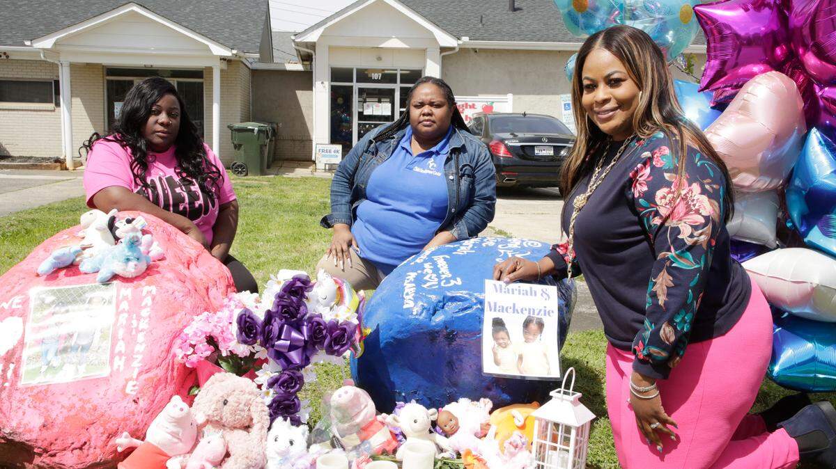 From left, teacher Tara Parker, floor director Kianna Sanders and owner of Right Choice Child Development, Center, Sidnetrice Williams, kneel next to a memorial for a mother and her twin daughters who were killed in a deadly crash on March 22. Tionese Crim Hughes and her twin daughters Mackenzie and Mariah Hughes were in a car accident outside Rock Hill.