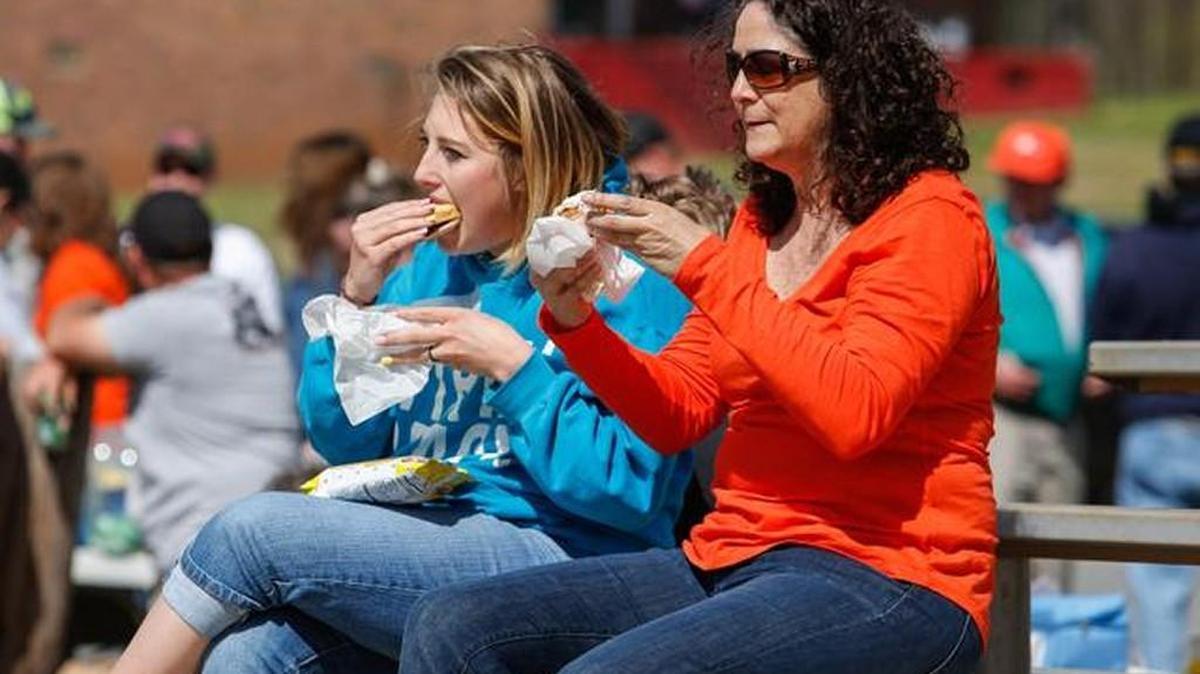 Brittany and Delois McDaniel take a food break as the Hickory Grove Volunteer Fire Department holds its annual Hash, Barbecue and Tractor show.