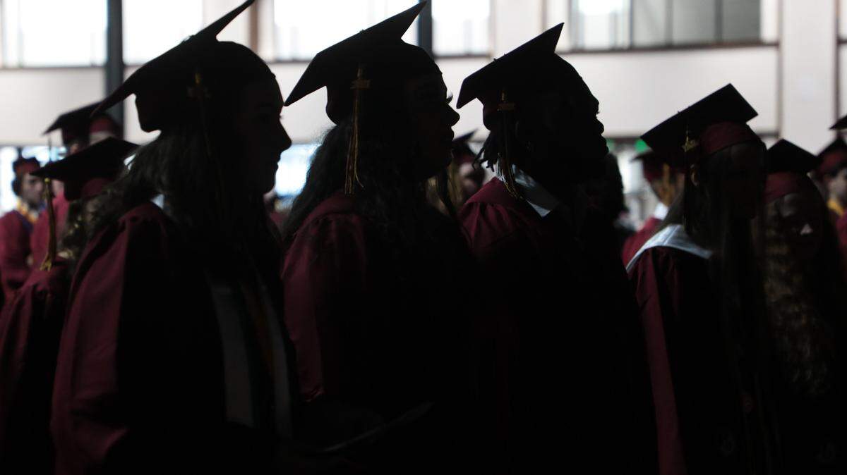 Rock Hill High School graduates listen to opening statements Thursday after entering the Rock Hill Sports and Events Center for the graduation ceremony.
