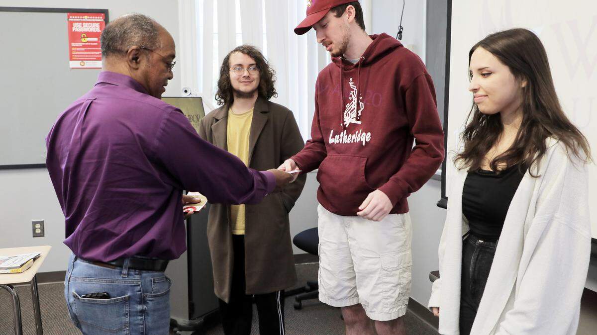 Herald Editor Cliff Harrington, left, hands out gift cards to Winthrop University mass communication students, second from left, Chase Duncan, Matthew Shealy and Abigail Helm Wednesday. The students received the Terry Plumb Awards.