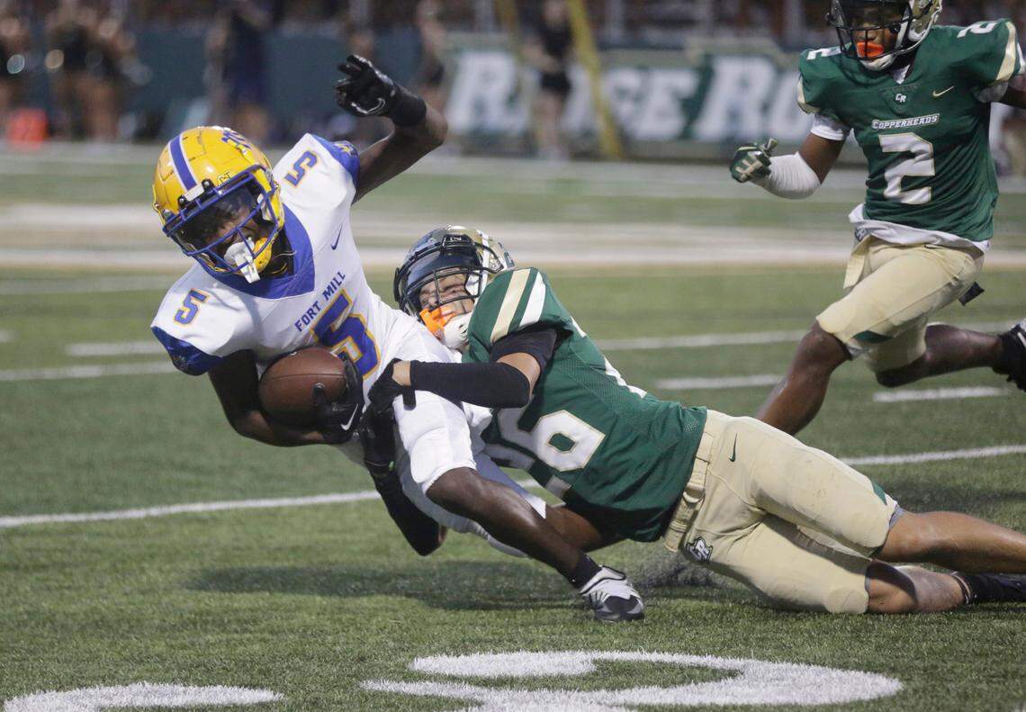 Catawba Ridge’s Tristian Swartzman (26), tackles Fort Mill’s Jeremiah McNeil in a 2023 game. The Fort Mill School District is a big reason people move to Fort Mill, and it’s gone from one high school to three in less than two decades to make room for all of them.