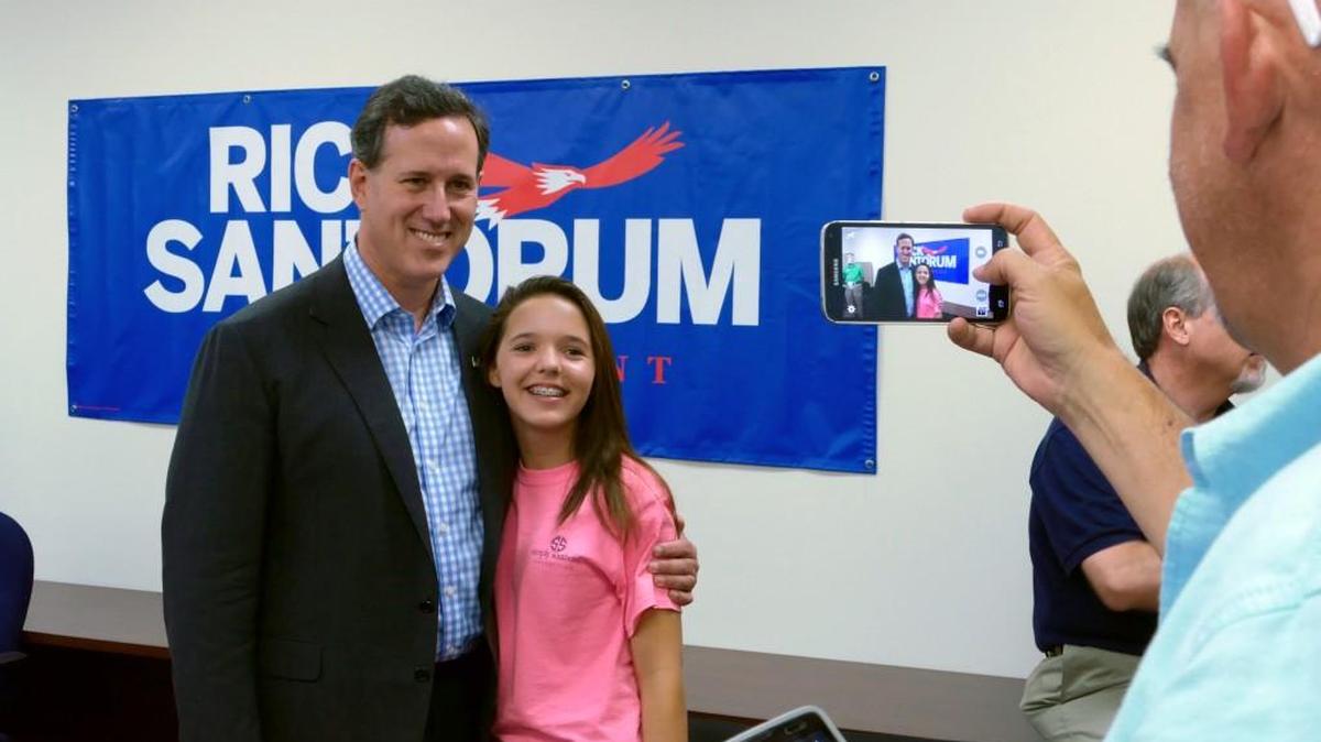 Joe St. John takes a photo of his daughter, Mary, with Republican presidential candidate Rick Santorum during his last campaign visit to York County in May.