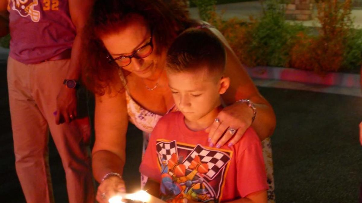 Donna Vayda and her grandson, R.J. Ream, light candles during Sunday night’s vigil in Richburg, which honored the victims of a mass shooting at an Orlando nightclub.