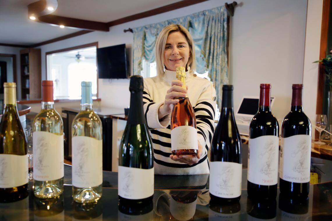 Jenna Bice holds up a bottle of bubbly rose at the Laurel Haven Estate and winery in Lancaster County, South Carolina.