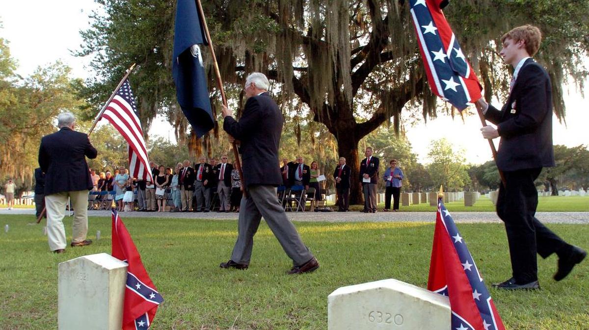 In this file photo from 2011, the crowd stands at attention for the Presentation of Colours at the start of the Confederate Memorial Day Service at the Beaufort National Cemetery.
