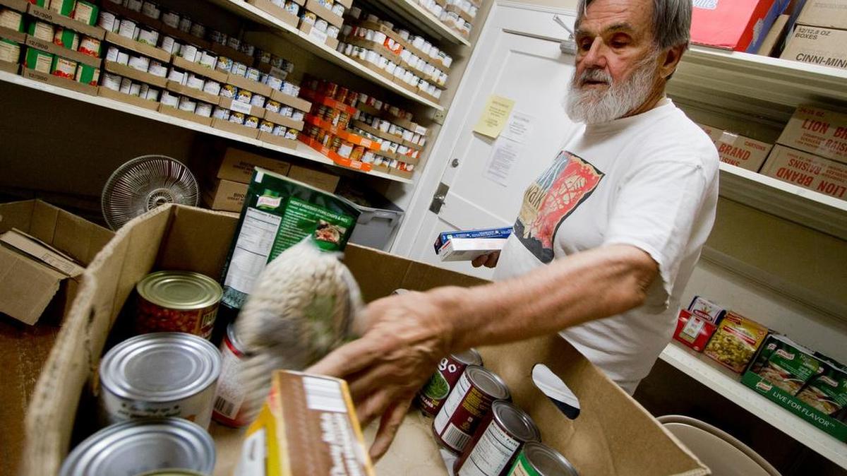 John Chura, a volunteer from St. Anthony the Great Orthodox Church, loads a box of groceries Thursday at Project Hope on Park Avenue in Rock Hill.