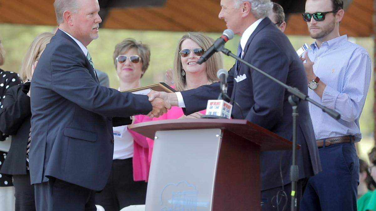Retired Fort Mill police chief Jeff Helms, left, shakes hands with S.C. Gov. Henry McMaster Thursday in Fort Mill. McMaster gave Helms the Order of the Palmetto — the highest civilian honor in S.C.