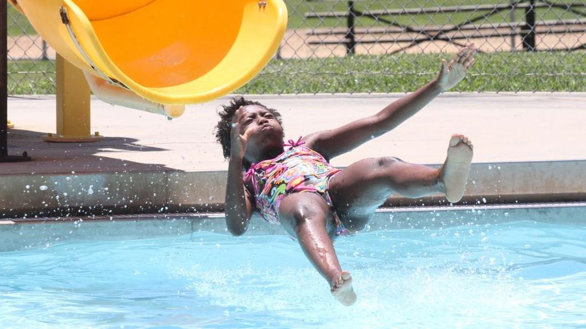 Zakyia Meeks, 9, flies out of a slide Thursday at the Boyd Hill Recreation Center pool. The Rock Hill city pools opened this week.