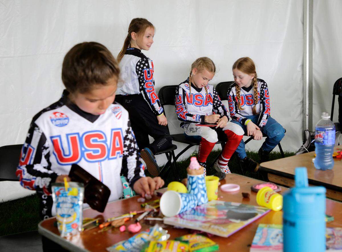 Irelyn McGinley, right, talks with friends before the 8-year-old girls race at the BMX World Championships in Rock Hill on Monday.