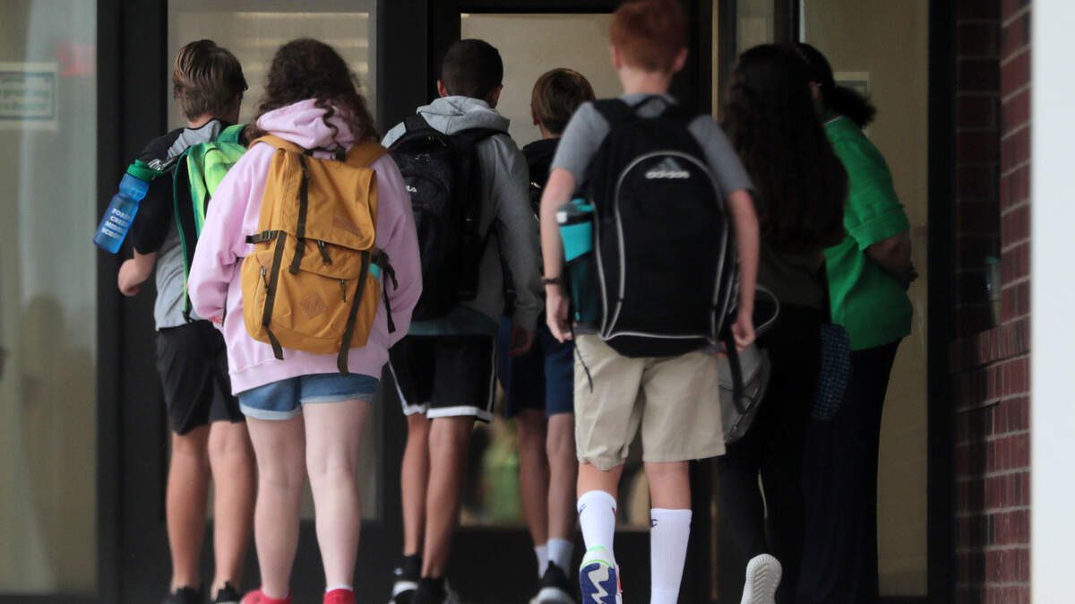 Students file into Forest Creek Middle School Monday, a new school in the Fort School District.