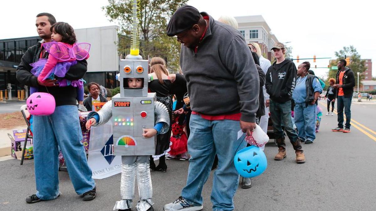 Trick-or-Treaters, including Josiah Burnett, 5, center, celebrate Halloween at Boo Ha-Ha in downtown Rock Hill at Fountain Park, on Saturday.