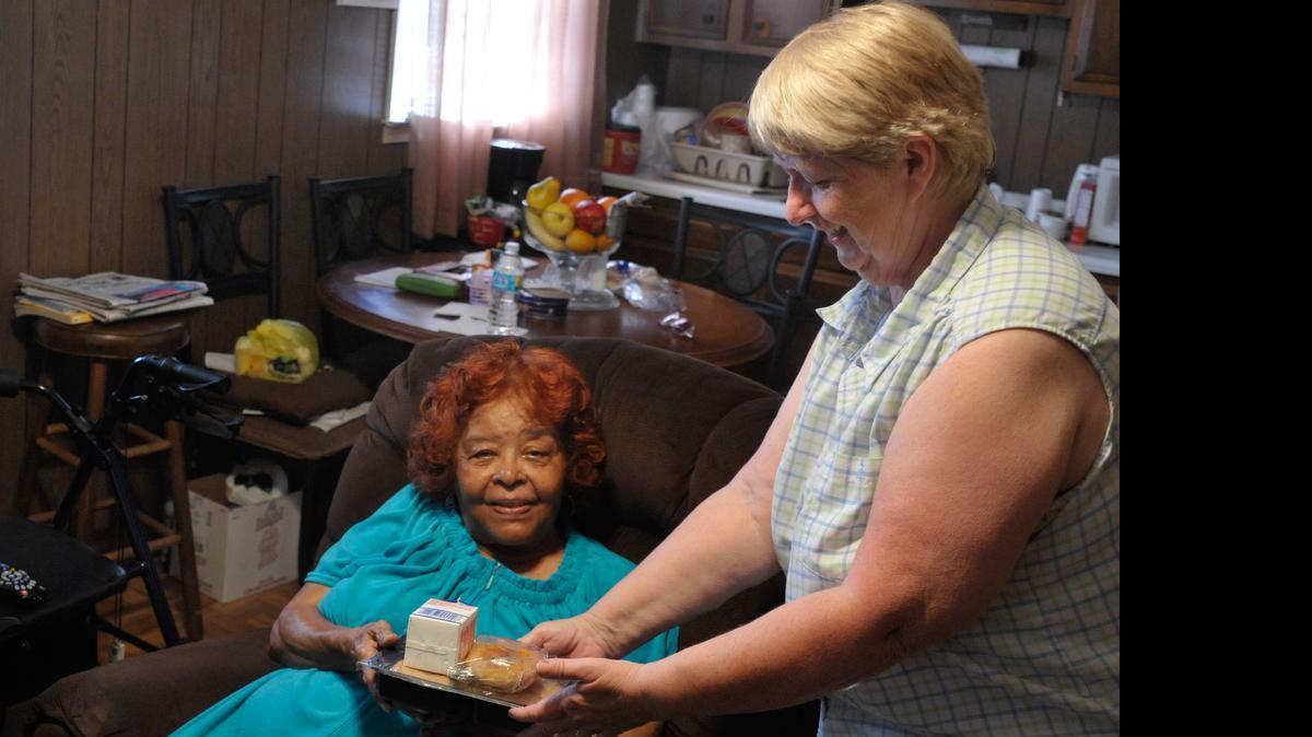 
York County Council on Aging volunteer Betty Lawrence, right, delivers a meal to the home of Alice Beckham on Tuesday.
