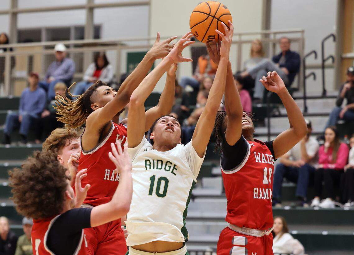 Catawba Ridge’s Lance Barnes (10) reaches for the ball with Wade Hampton’s Taquavion McKinney, left, and Ayinde Burnside, right. Catawba Ridge opened in 2019 to serve the fast-growing southern portion of Fort Mill where large, new homes continue to pop up in neighborhoods like Waterside at the Catawba or Elizabeth.