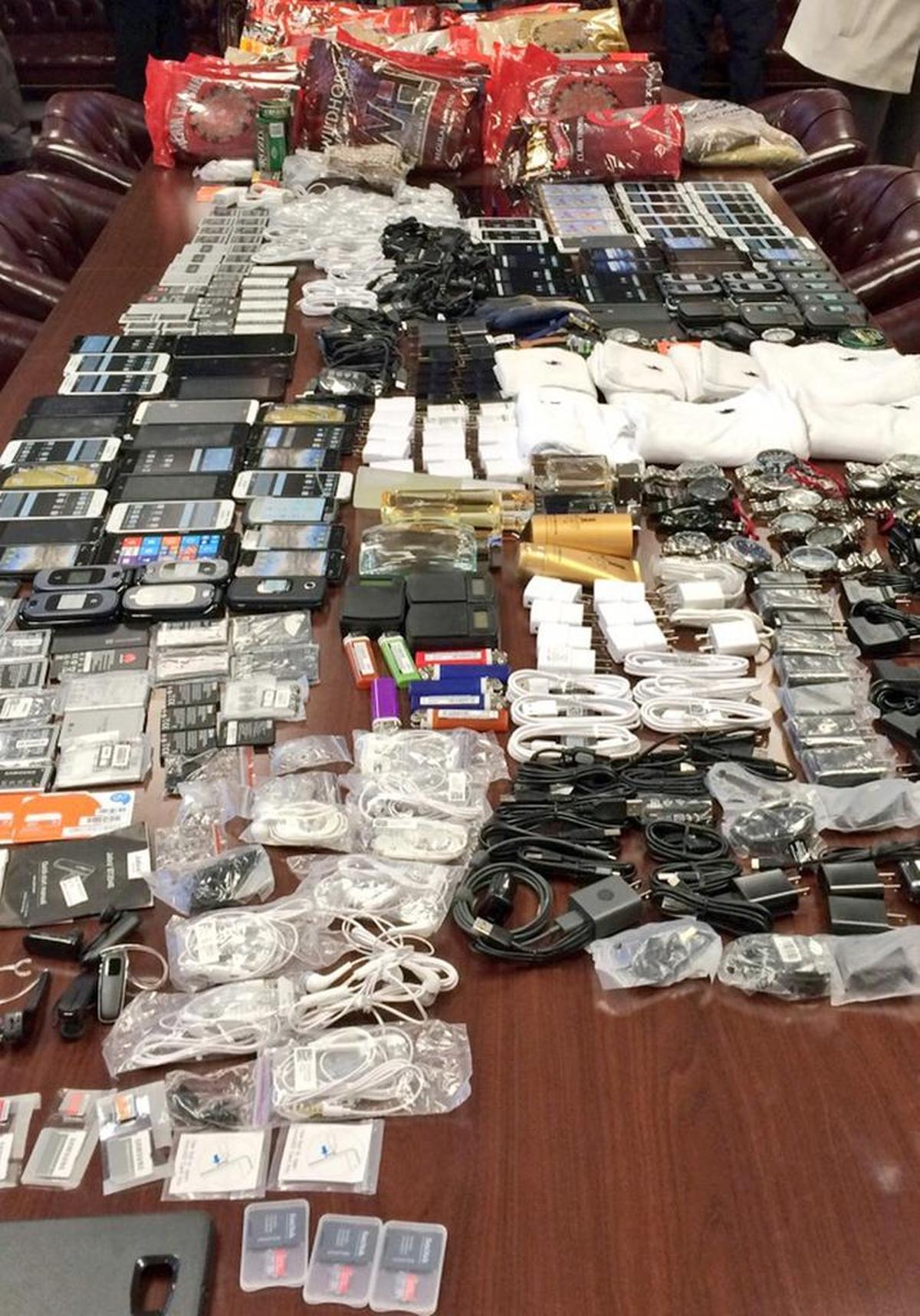 Cell phones and other contraband are displayed after being seized in a single raid at Lee Correctional Institution in 2016.