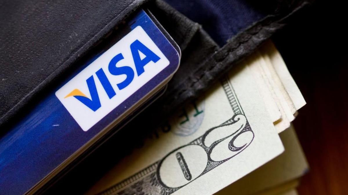 In this Feb. 2, 2011, file photo, a wallet containing cash and a Visa card is displayed. A York County business owner said he was swindled out of $3,000 by scammers who prey upon both businesses and residents in Rock Hill.