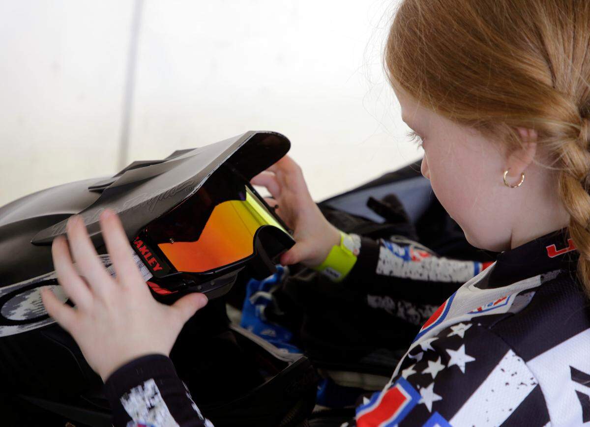 8-year-old Irelyn McGinley adjusts her helmet Monday at the BMX World Championships in Rock Hill.
