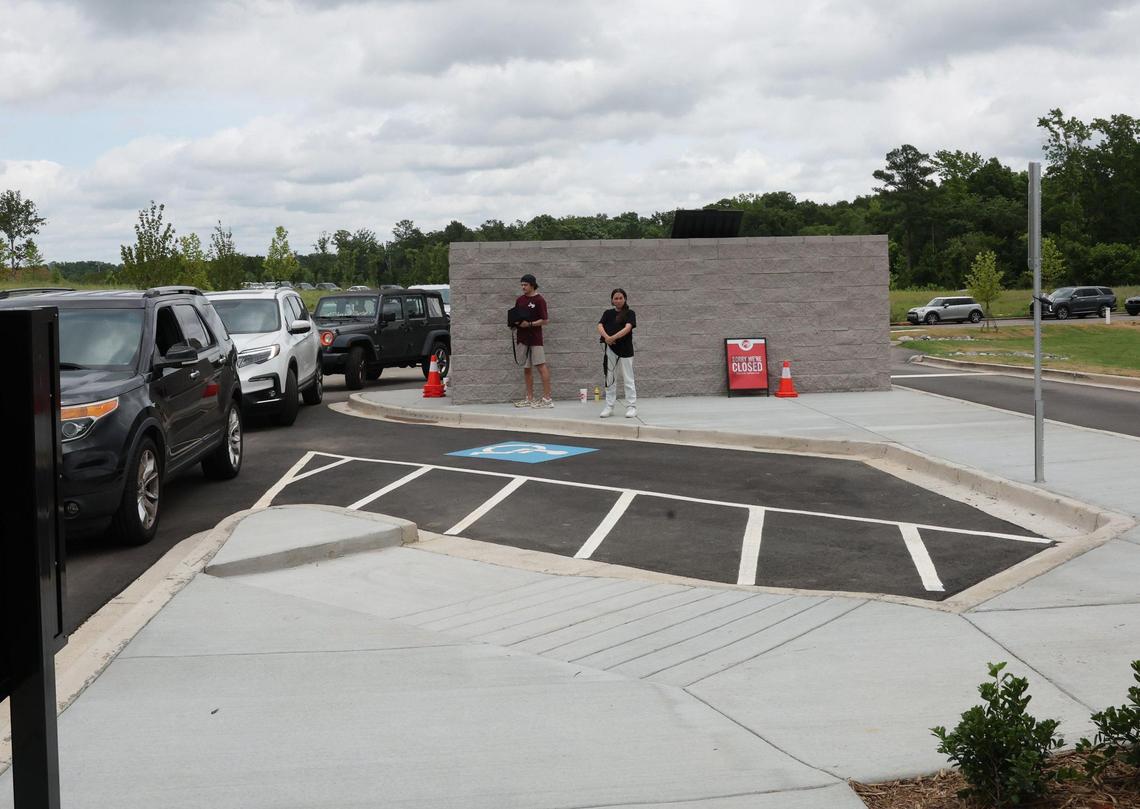 Employees at Swig watch as cars wait in line at the popular soda shop Friday, May 30, 2025 in Indian Land, S.C.