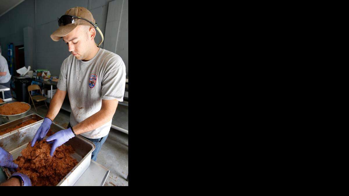 
Volunteer firefighter Mitchell Bechtler helps make barbecue Thursday. The Oakdale Fire Department will hold its annual barbecue Friday from 10 a.m. until 7 p.m. and Saturday from 10 a.m. until sold out. The fire station is located at 2633 Saluda Road in Rock Hill. 
