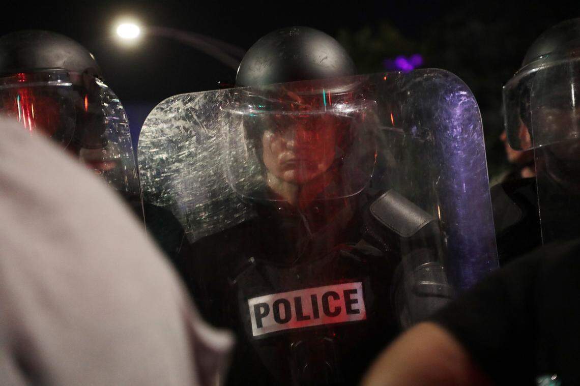 A Rock Hill police officer stands in riot gear in front of protesters downtown in June 2021.