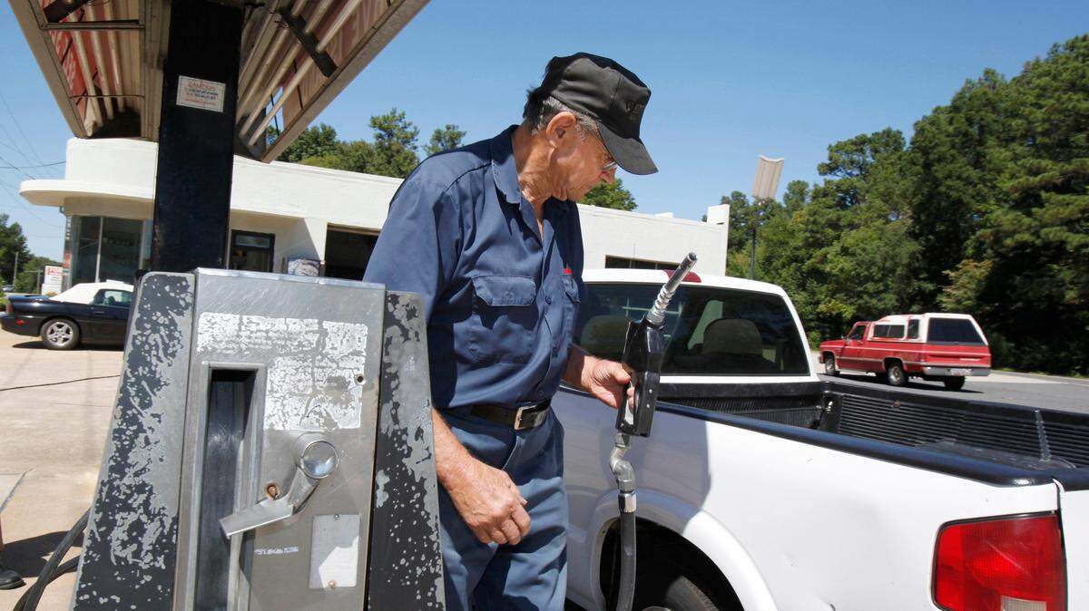 In this file photo from 2012, Carl Jackson pumps gas at the family gas station on Anderson Road in Rock Hill. The station closed in 2014. Jackson, who pumped gas at the full-service station into his 80s, died March 11 at age 88.