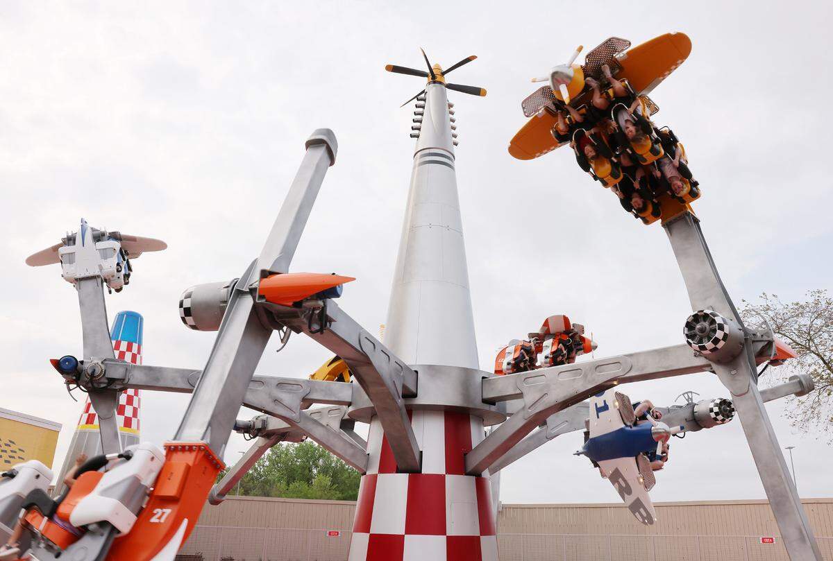 Riders scream as they fly upside down Thursday on the Air Racers attraction at Carowinds’ new Aeronautica Landing.